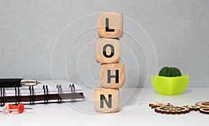 word LOHN on wooden block, business concept