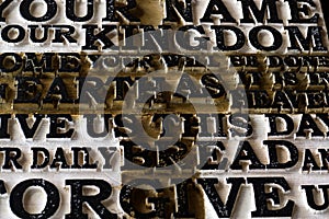 Word of the Lord`s Prayer on the old black weathered wooden pla