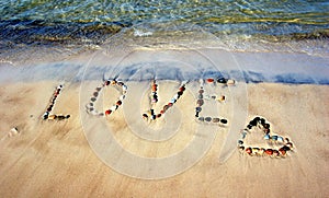 Word LOVE on beach sand