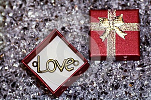 The word `love` in a box for jewelry, Pendant `Love`, a declaration of love,