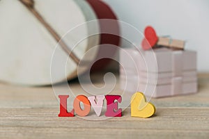 Word Love is composed of wooden multi-colored letters.
