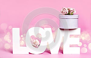 Word Love and gift box at pink color background