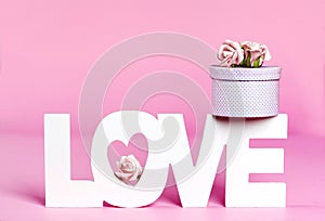 Word Love and gift box at pink color background