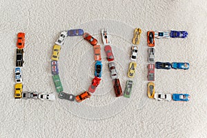 Word love made of little cars.