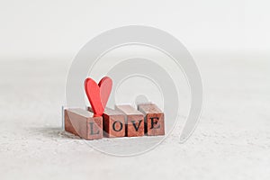 The word Love made up of wooden rectangles with letters.