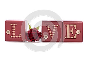 Word love with red rose