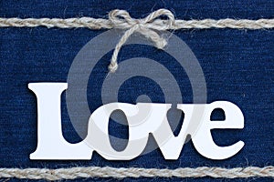 The word Love with rope border and bow on denim