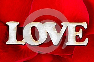 Word Love with rose petals. Sweet holiday background. Valentines Day Card.