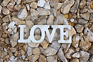 The word love on a stone background.
