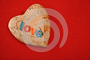 The word love on top of a wooden heart