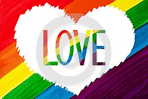 Word LOVE in white heart isolated on rainbow color background close up, LGBT flag banner, LGBTQ poster, lesbian, gay etc symbol