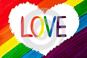 Word LOVE in white heart isolated on rainbow colors background closeup, LGBT flag banner, LGBTQ poster, lesbian, gay etc symbol