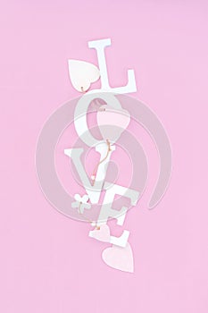 Word love from white volume letters on pink background