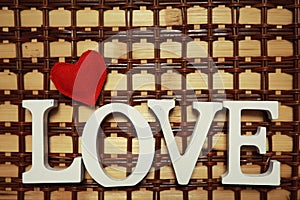 Word Love from wooden letters on background