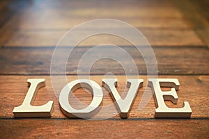 Word Love from wooden letters on background