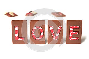 Word love writing on chocolate on white background