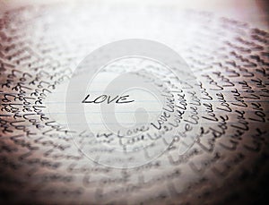 The word love written on a lined piece of school paper