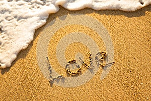 The word LOVE written in the sand on the beach