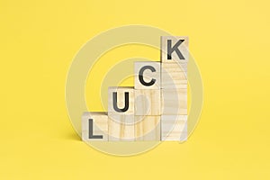 the word LUCK is written on a wooden cubes, concept