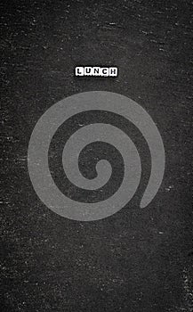 Word lunch on black stone background