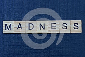 word madness from gray wooden letters