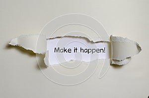 The word make it happen appearing behind torn paper.