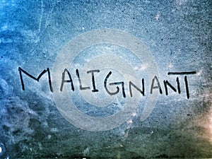 word malignant on the lite blue color paper page photo