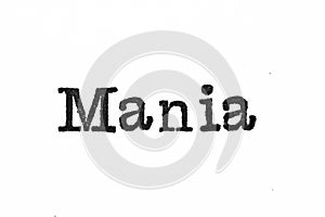The word `Mania` from a typewriter on white
