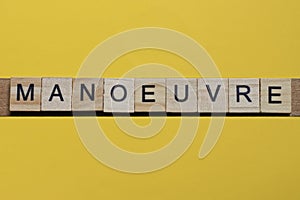 the word manoeuvre of gray small wooden letters