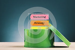 word MARKETING STRATEGY on sticky paper over beautiful reverberation gradient background