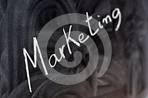 The word marketing written with a chalk on the blackboard photo