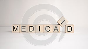 The word medicaid is written on wooden cubes on a light background. Business concept