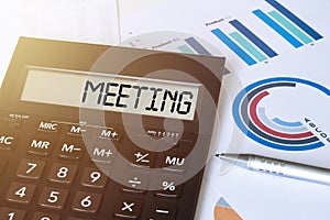 Word MEETING on calculator. Business and finance concept