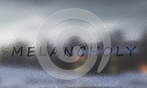 The word Melancholy and raindrops on the window glass against dark background. The concept mood. 3d rendering