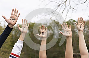 Word merci written on child hands