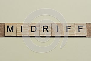 word midriff made of wooden square letters