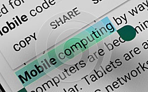 Word `Mobile computing` selected and highlighted digitally on mobile display screen