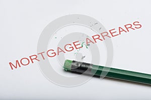 Word `Mortgage Arrears` with Worn Pencil Eraser and Shavings