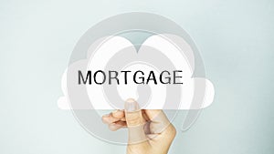 The word MORTGAGE is written on a white sheet