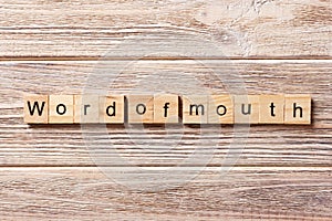 Word of Mouth word written on wood block. Word of Mouth text on table, concept