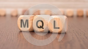 word mql - marketing qualified lead - is written on wooden cubes