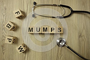 Word mumps from wooden blocks with stethoscope