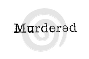 The word `Murdered` from a typewriter on white photo