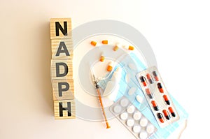 The word NADPH is made of wooden cubes on a white background. Medical concept photo