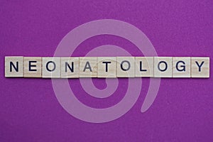 Word neonatology from small gray wooden letters