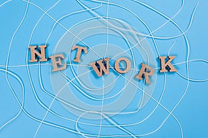 The word network with wooden letters in the form of an abstract spider web