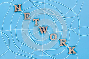 The word network with wooden letters in the form of an abstract spider web