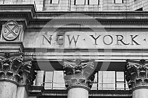 Word New York engraved on the old building facade in NYC, USA