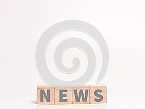 Word news on wooden cubes against white background.