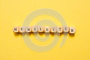 the word Newsletter, text made with dice on yellow background